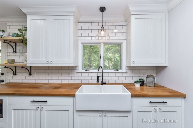 232 S Randall Rd, Aurora, IL 60506 - kitchen featuring wooden counters, a sink, open shelves, tasteful backsplash, and crown molding