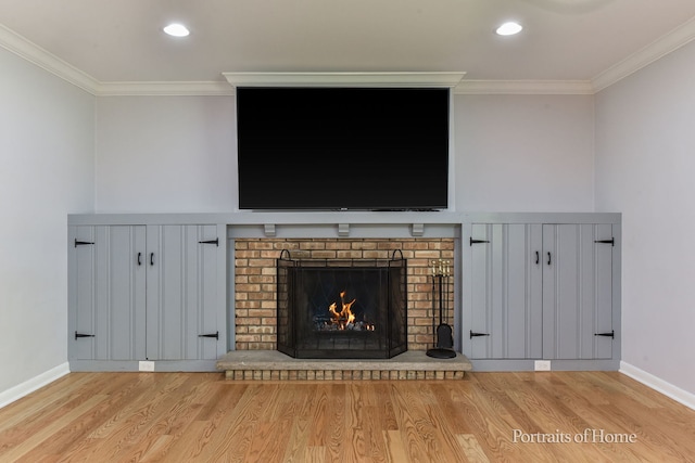 232 S Randall Rd, Aurora, IL 60506 - detailed view of wood finished floors, ornamental molding, baseboards, a brick fireplace, and recessed lighting