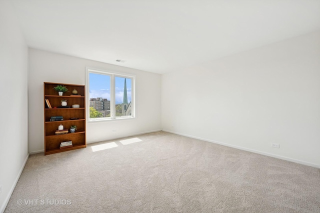 empty room with carpet and baseboards