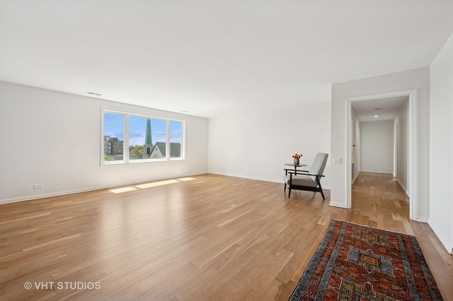 spare room with light wood finished floors and baseboards
