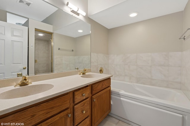 full bathroom with a sink, double vanity, a shower stall, and visible vents