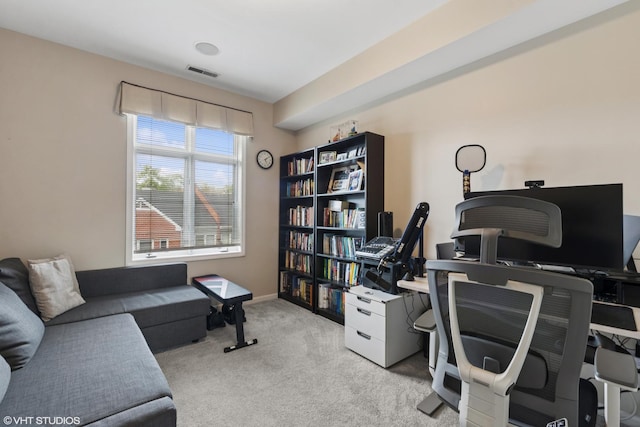 home office featuring light colored carpet, baseboards, and visible vents