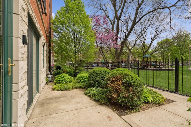 exterior space with a patio area, fence, and a lawn