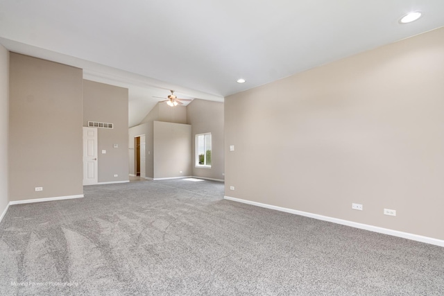 spare room with baseboards, carpet, and lofted ceiling