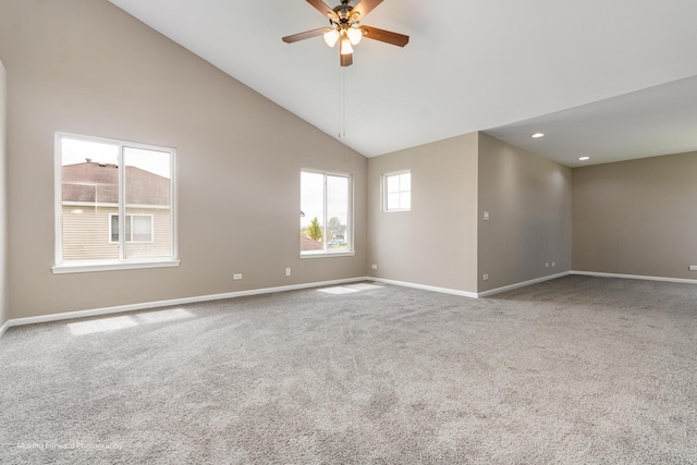 empty room with carpet floors, a ceiling fan, baseboards, and high vaulted ceiling