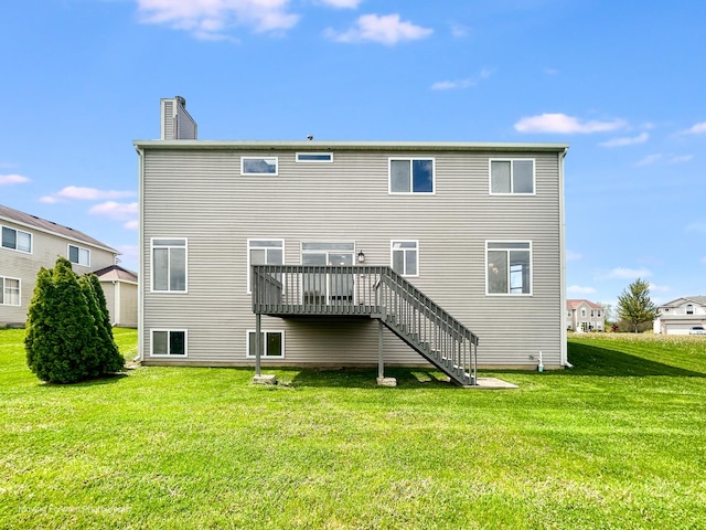 rear view of house with a lawn, a deck, a chimney, and stairway