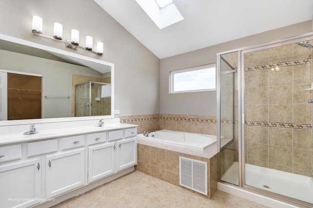 bathroom with visible vents, lofted ceiling with skylight, a bath, a shower stall, and a sink
