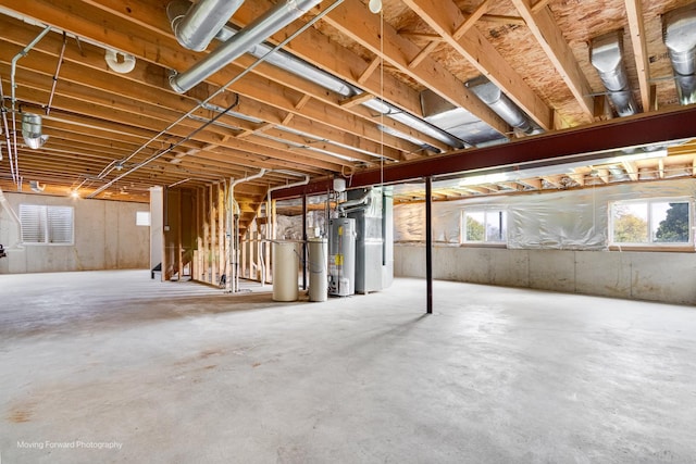 below grade area featuring heating unit and water heater