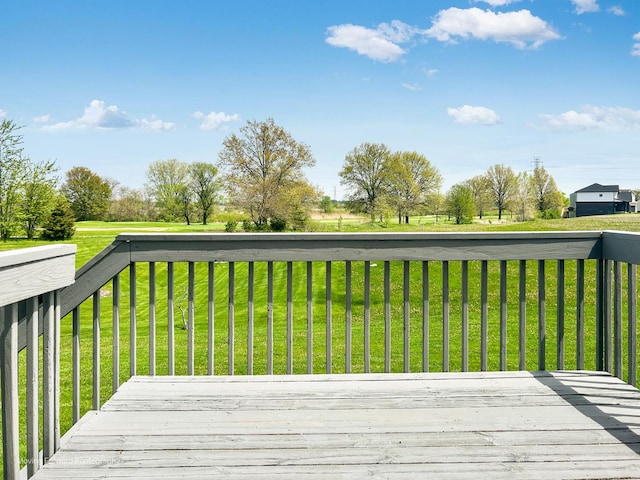 wooden terrace featuring a lawn