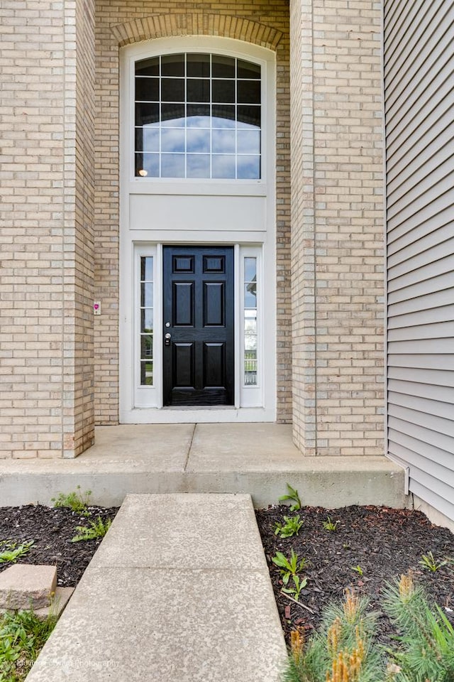 entrance to property with brick siding