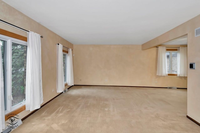 unfurnished room with visible vents, carpet flooring, and baseboards