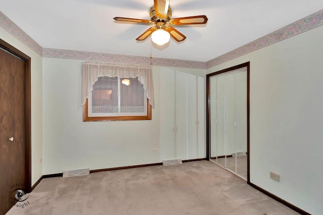 unfurnished bedroom with carpet floors, baseboards, a closet, and visible vents