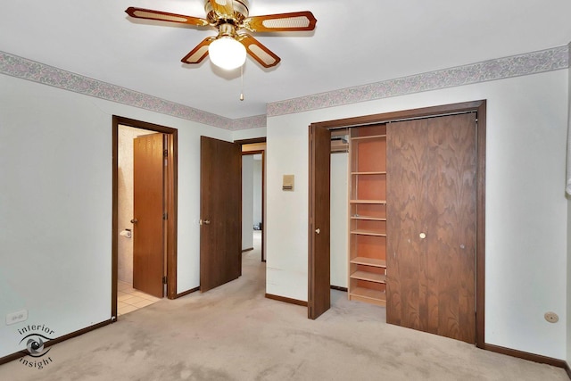 unfurnished bedroom with a ceiling fan, baseboards, light carpet, and a closet
