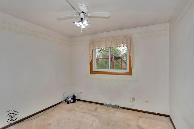 carpeted empty room with baseboards, a ceiling fan, and visible vents