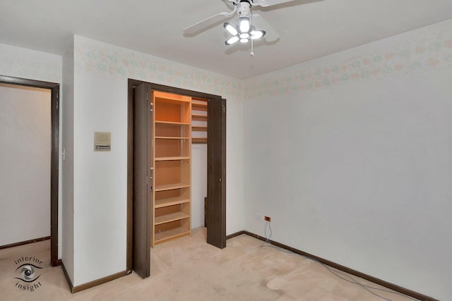 unfurnished bedroom featuring baseboards, light carpet, ceiling fan, and a closet