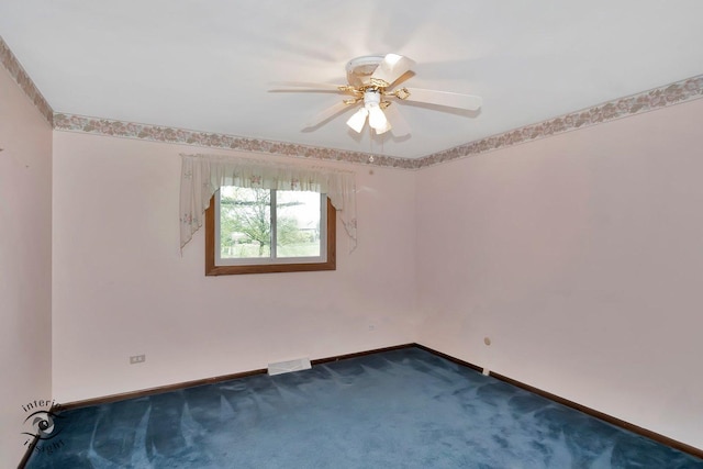 carpeted spare room with baseboards, a ceiling fan, and visible vents