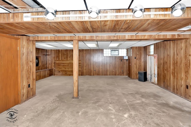 basement featuring wooden walls