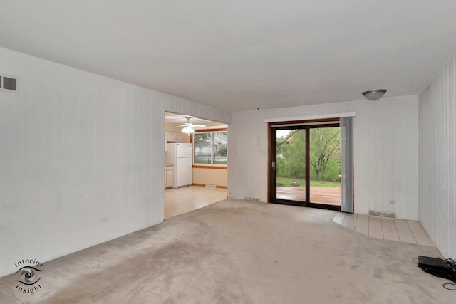 carpeted empty room featuring ceiling fan and visible vents