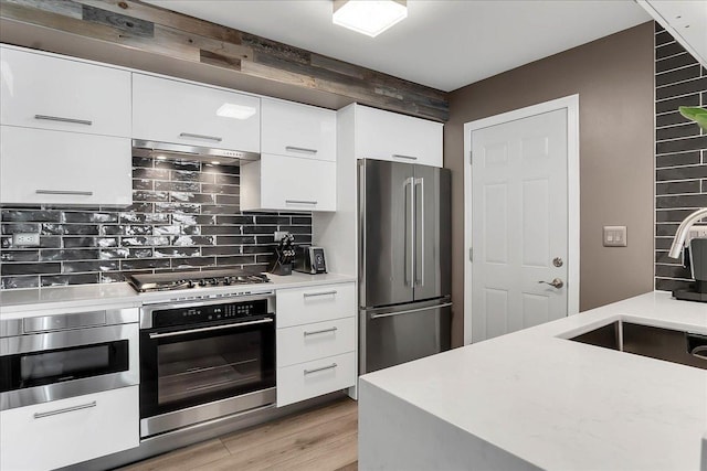 436 Yorktown Ct, Aurora, IL 60504 - kitchen with modern cabinets, light countertops, under cabinet range hood, white cabinets, and stainless steel appliances