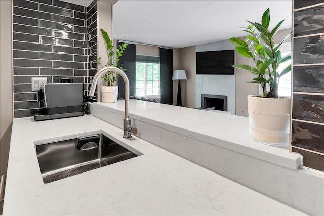 436 Yorktown Ct, Aurora, IL 60504 - interior space with light countertops, a sink, a fireplace, and tasteful backsplash