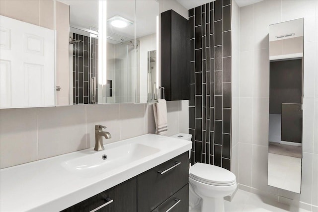 436 Yorktown Ct, Aurora, IL 60504 - full bathroom featuring vanity, toilet, tile patterned floors, tile walls, and a shower stall