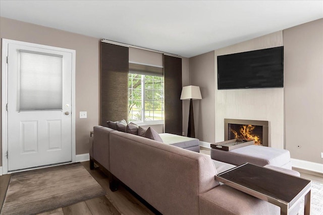 436 Yorktown Ct, Aurora, IL 60504 - living room featuring baseboards, wood finished floors, and a warm lit fireplace