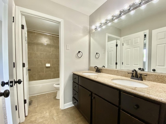 full bathroom featuring toilet, double vanity, baseboards, bathing tub / shower combination, and tile patterned flooring