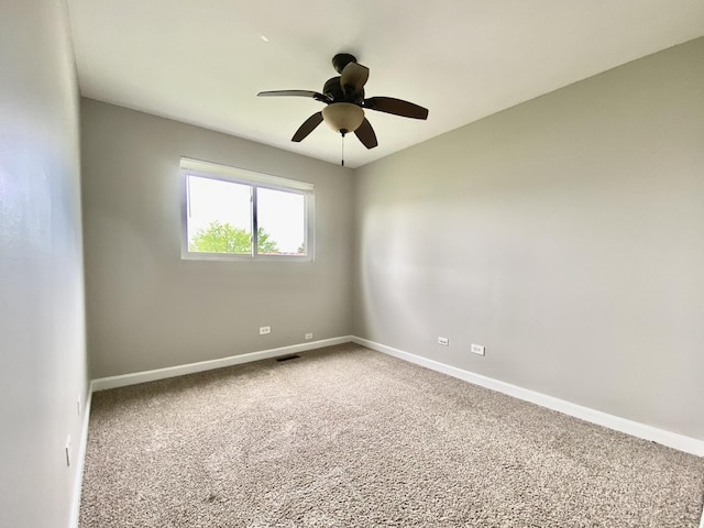 unfurnished room with carpet flooring, ceiling fan, and baseboards
