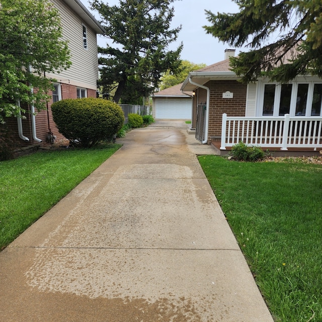 5900 W 110th St, Chicago Ridge, IL 60415 - view of home's exterior with a porch, brick siding, a lawn, and a detached garage