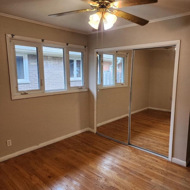 5900 W 110th St, Chicago Ridge, IL 60415 - unfurnished bedroom featuring crown molding, a closet, baseboards, and wood finished floors