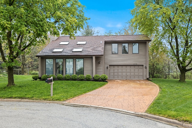 view of front of house featuring a chimney, a front yard, a garage, decorative driveway, and a shingled roof