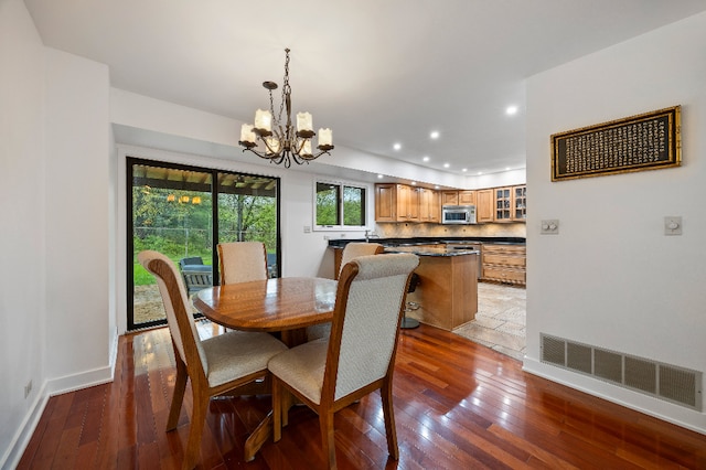 dining area with visible vents, a chandelier, recessed lighting, and hardwood / wood-style flooring