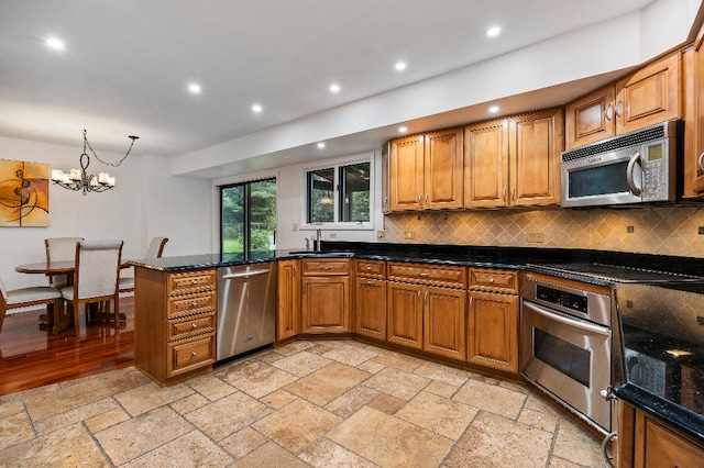 kitchen featuring tasteful backsplash, brown cabinets, stainless steel appliances, recessed lighting, and stone tile floors