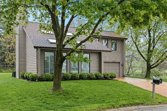 view of front of property with driveway, a chimney, a front yard, a garage, and a shingled roof