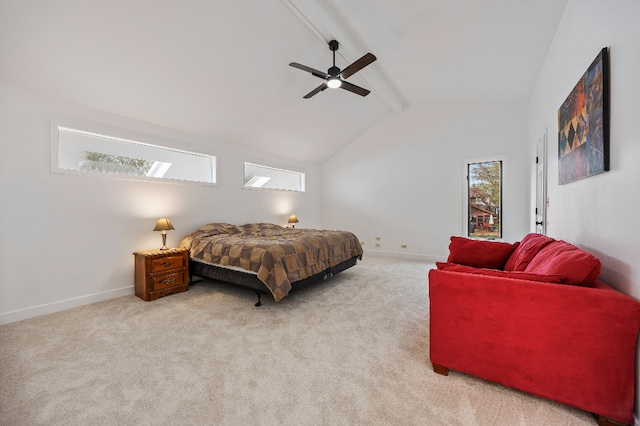 carpeted bedroom with baseboards, a ceiling fan, and lofted ceiling with skylight