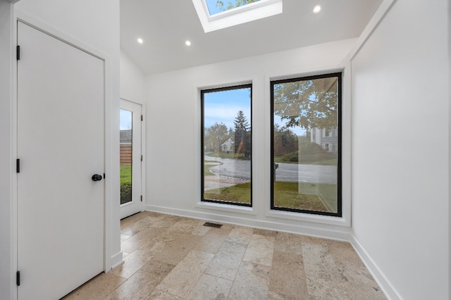 empty room featuring recessed lighting, stone tile floors, and a healthy amount of sunlight