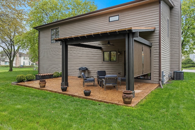 rear view of house featuring a patio, ceiling fan, central air condition unit, and a yard