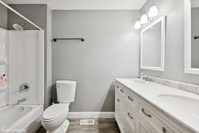 223 Hickory Ln, Schaumburg, IL 60193 - full bath featuring baseboards, washtub / shower combination, double vanity, toilet, and wood finished floors
