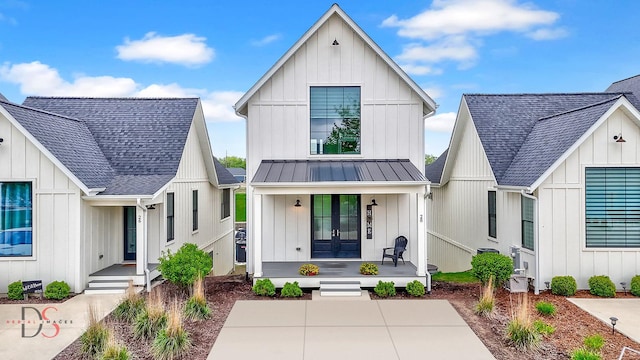 modern inspired farmhouse featuring roof with shingles, board and batten siding, a porch, and french doors