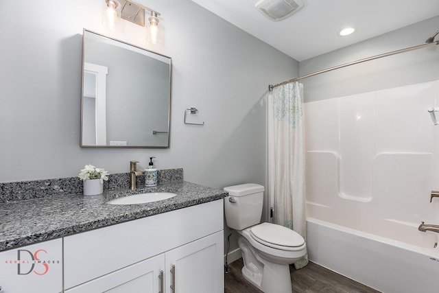 full bath with shower / bath combination with curtain, toilet, wood finished floors, visible vents, and vanity