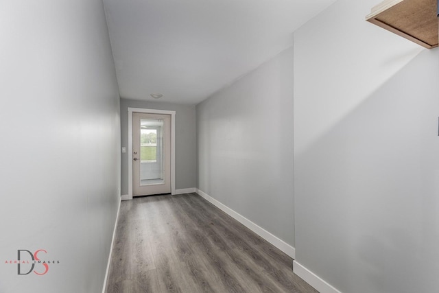 entryway with baseboards and wood finished floors
