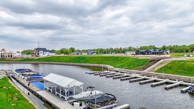 view of dock with a yard and a water view