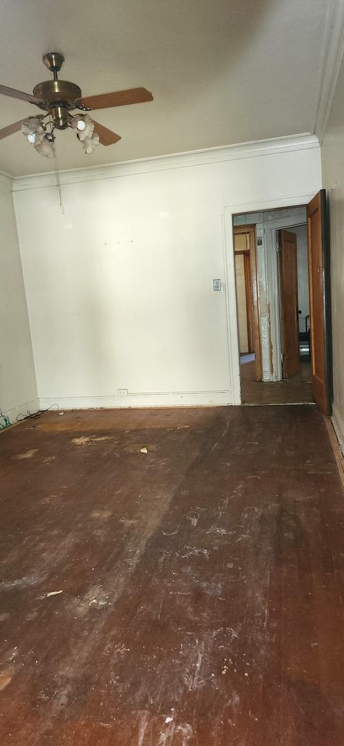 7943 S Vernon Ave, Chicago, IL 60619 - spare room featuring crown molding, wood-type flooring, and ceiling fan