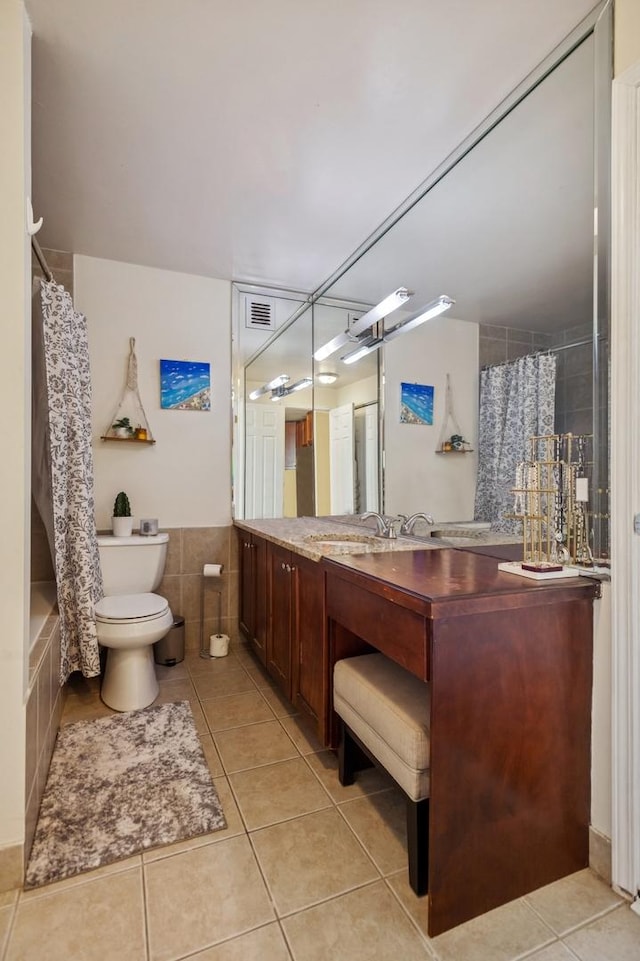 bathroom featuring tile walls, toilet, visible vents, tile patterned flooring, and vanity