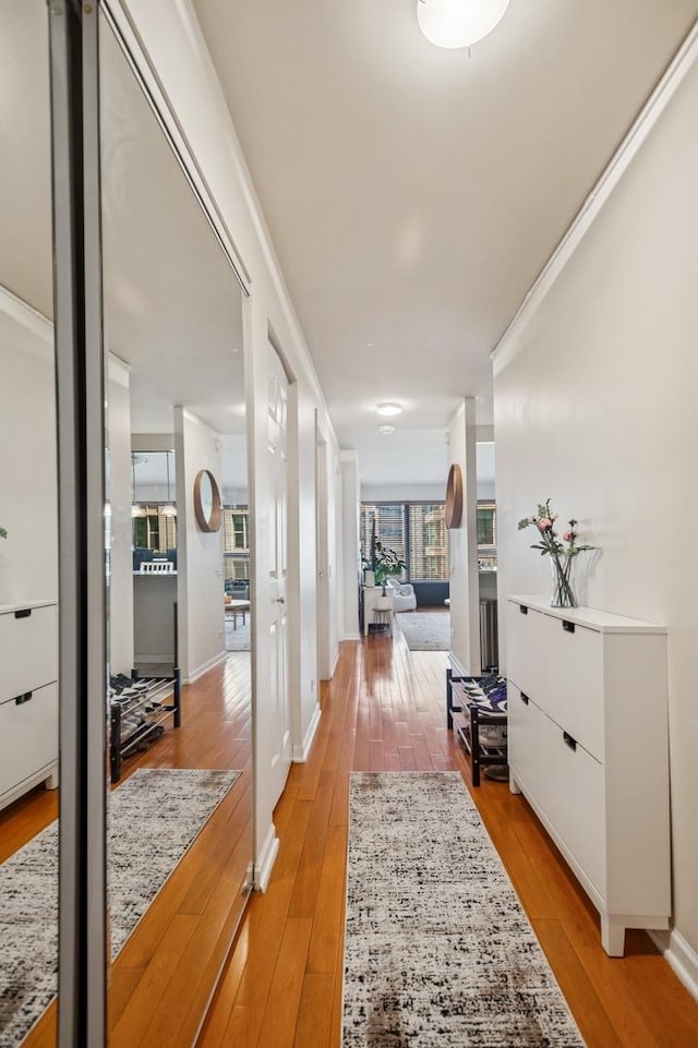 hallway with baseboards and light wood finished floors