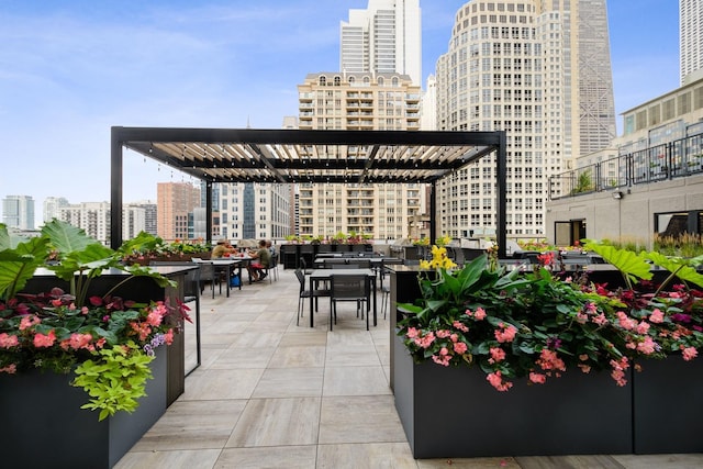 view of patio featuring outdoor dining space and a city view