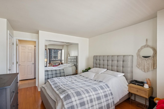 bedroom featuring light wood finished floors and a closet
