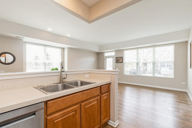 13472 Delaney Rd, Huntley, IL 60142 - kitchen featuring dishwasher, a sink, light wood-style floors, light countertops, and brown cabinetry