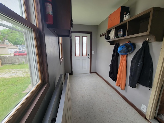 mudroom featuring baseboards and light floors