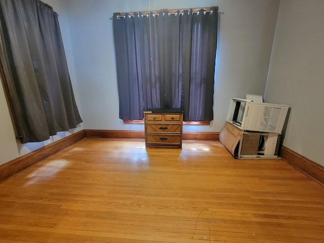 unfurnished bedroom featuring light wood-style flooring and baseboards